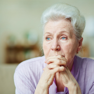 Older adult woman appearing sad.